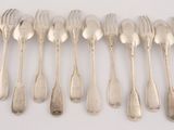eight silverplated spoons and forks arranged in a row on a white surface