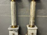 pair of white and gold marble pedestals with stars on them