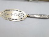 a silver spoon with a silver handle on a table