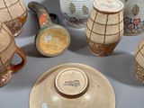 many vases that are sitting on a table