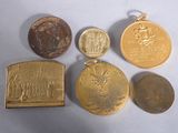 four different types of gold coins are shown on a white surface