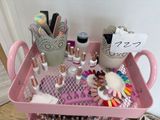 a pink rolling cart with a lot of nail polish and accessories on it