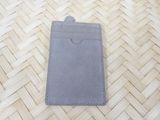grey leather card holder on a wooden floor