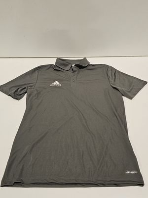 a grey shirt with a white logo on the chest