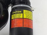 a close up of a black fire hydrant on a white table