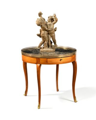 a small table with a statue on top of it