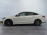 the white bmw m140i sedan is parked in a parking lot