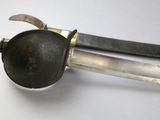 a close up of a knife and a spoon on a table