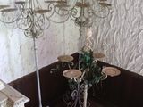 a table with three candles on it in the corner of a room