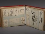 an open book with drawings on it on a table