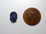 an image of a coin and a blue scarra on a white surface
