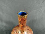 a vase that is sitting on a table with a gray background