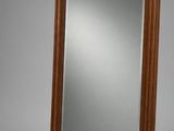 a large mirror with a wooden frame on a gray background