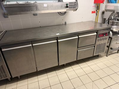 a kitchen with stainless steel counter tops and stainless steel cabinets