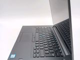 a laptop that is open on a white surface