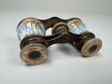 an old pair of binoculars sitting on top of a white surface