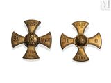 pair of antique iron crosses with a cross on each of them