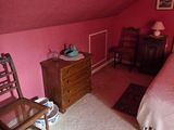 a bedroom with a bed and a chair in it