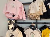 a display of clothing on a shelf in a store