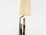 a table lamp with a lamp shade on top of it next to a pair of scissors