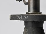 a close up of a metal object with a yellow object in the background