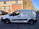 a white van parked in a parking lot next to a building