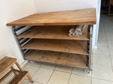 a wooden shelf with several shelves on it in a room