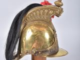 an image of a helmet with a long black hair on top of a wooden pole