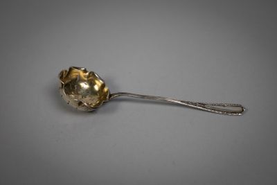a close up of a spoon with a flower on it