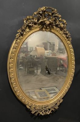 a mirror hanging on the wall with a city in the background