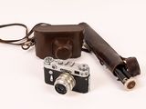 a camera and a case sitting on a white surface