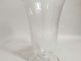 a glass vase that is sitting on a table
