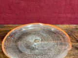 an orange and white bowl sitting on top of a wooden table