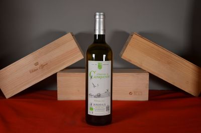 a bottle of wine sitting on a table next to two wooden boxes