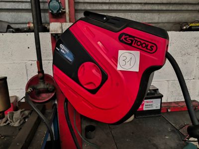 a red and black machine that is sitting in a garage
