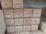 many boxes of wine sitting on a shelf in a room