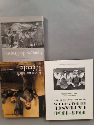 trois livres sont posés sur une table les uns à côté des autres