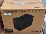 a box that is sitting on the floor next to a refrigerator