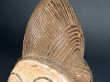 a close up of a wooden sculpture of a woman ' s head