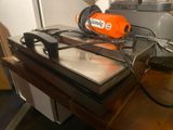 an orange blow dryer sitting on top of a table