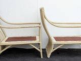 pair of vintage rattan lounge chairs with leather seat cushions