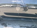 a reflection of a man riding a skateboard on the side of a car