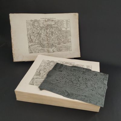 two old books sitting on top of a table next to each other