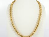 a gold beaded necklace on a mannequin mannequin mannequin mannequin mannequin mannequin mannequin mannequin mann