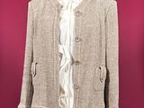 beige jacket on a mannequin stand against a red wall