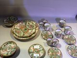 many plates and bowls sitting on a table