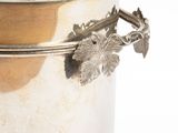 a silver container with a leaf design on the lid