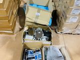 several boxes of electronics are stacked on the floor in a warehouse