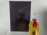 a bottle of perfume sitting on a clear table