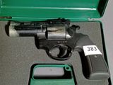 un pistolet dans un étui vert muni d'une étiquette